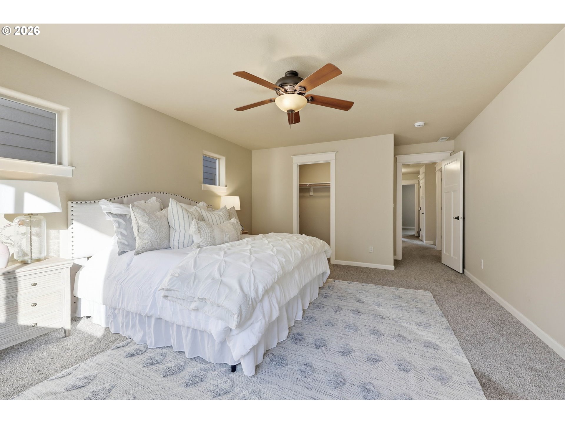 11033 Southwest Legacy Oak Way Portland, OR 97223 - Photo 17 of 47 a spacious bedroom with a bed and a ceiling fan