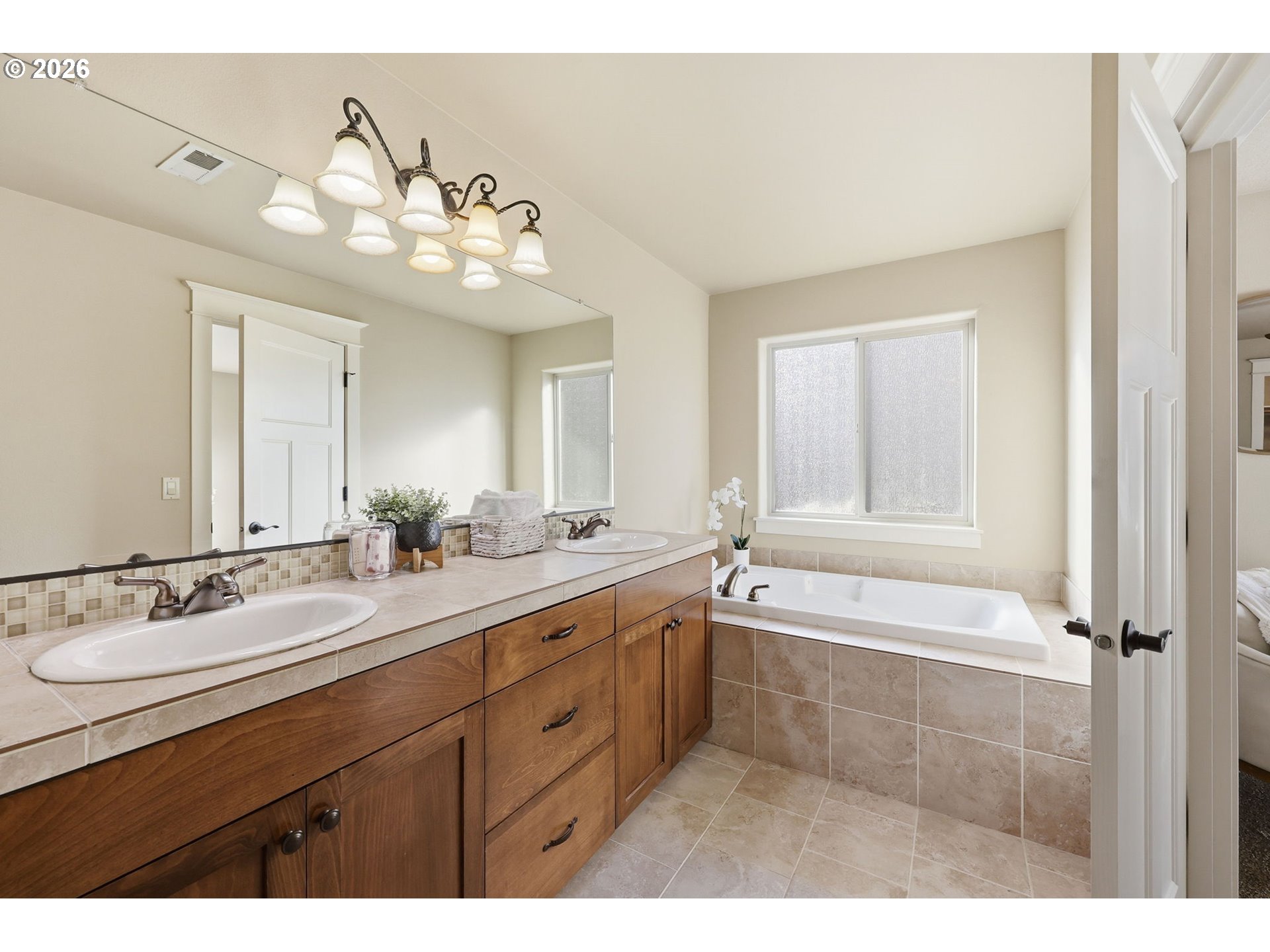 11033 Southwest Legacy Oak Way Portland, OR 97223 - Photo 20 of 47 a spacious bathroom with a sink mirror and a bathtub