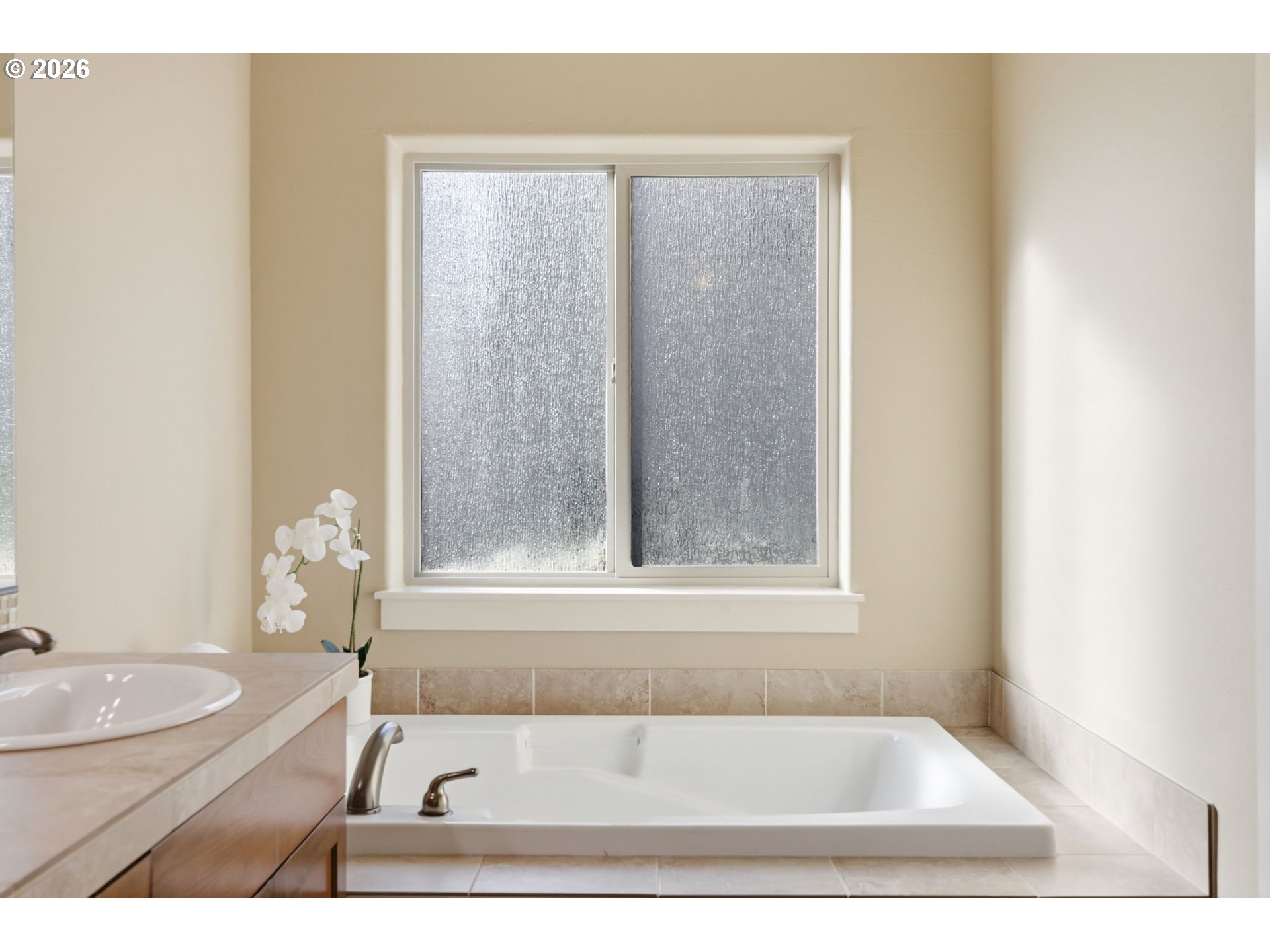 11033 Southwest Legacy Oak Way Portland, OR 97223 - Photo 21 of 47 a bathroom with a tub a sink and a window
