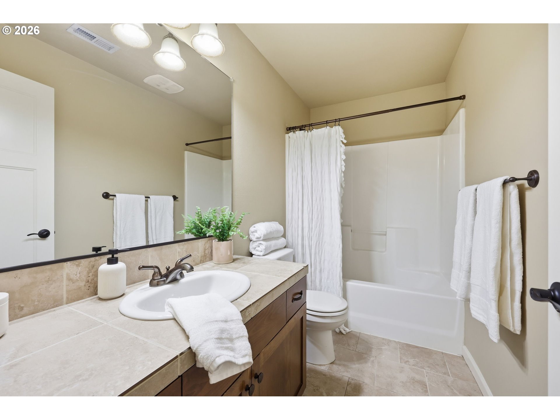 11033 Southwest Legacy Oak Way Portland, OR 97223 - Photo 26 of 47 a bathroom with a sink and mirror with bathtub