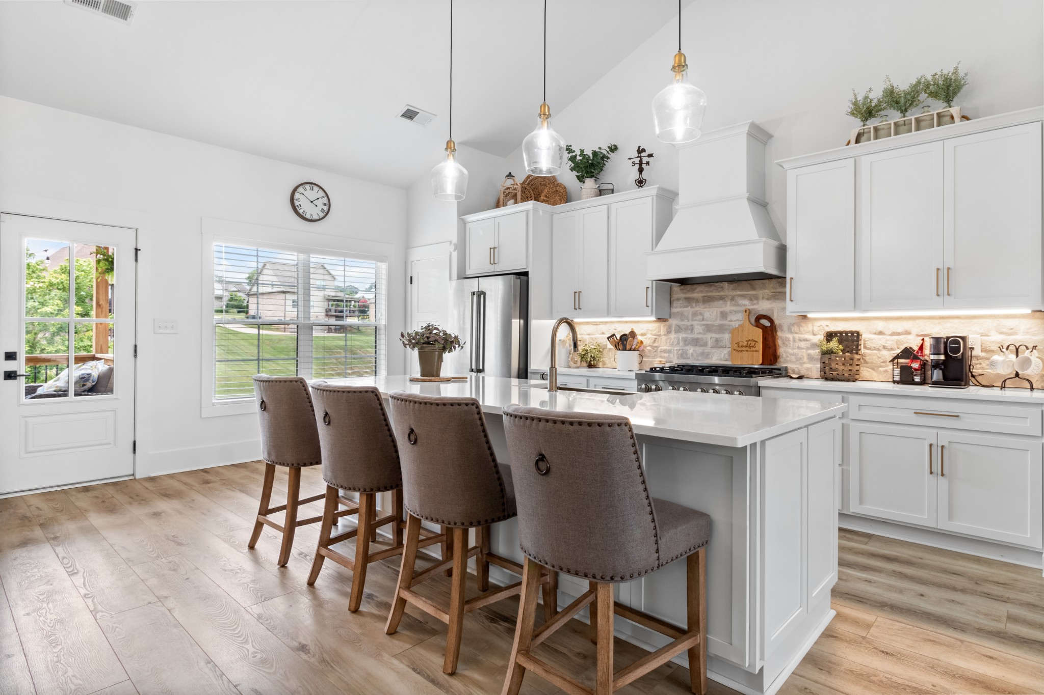 1188 Wicke Road Adams, TN 37010 - Photo 14 of 47 a kitchen with stainless steel appliances granite countertop a kitchen island hardwood floor sink and stove