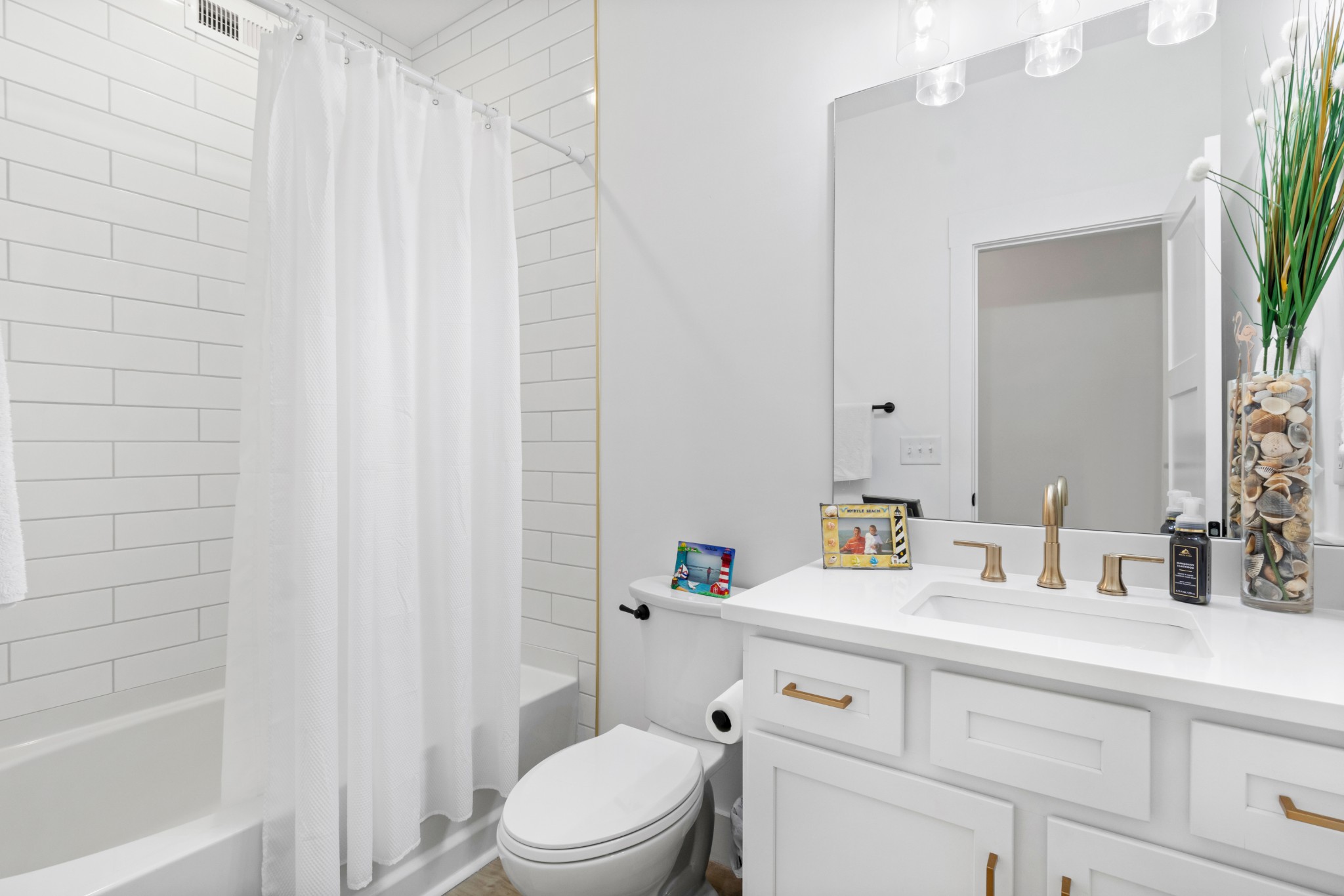 1188 Wicke Road Adams, TN 37010 - Photo 35 of 47 a bathroom with a sink a toilet and shower curtain