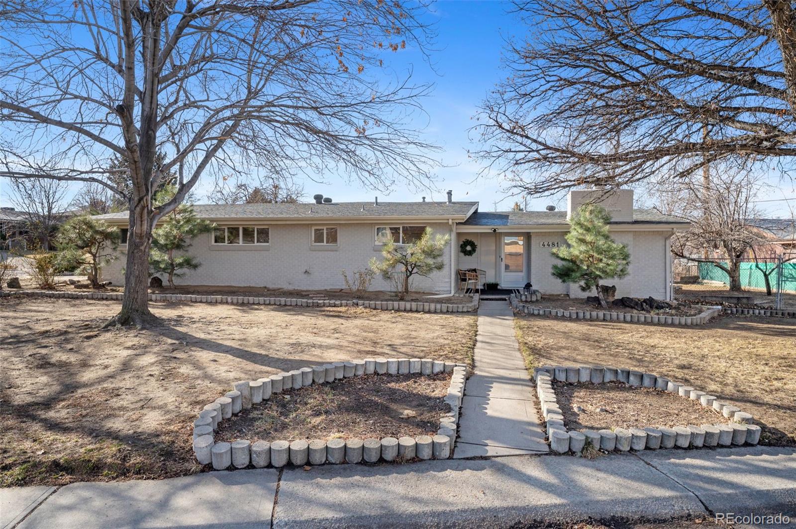 4481 Carr Street Wheat Ridge, CO 80033 - Photo 1 of 30 a view of a house with snow on the road