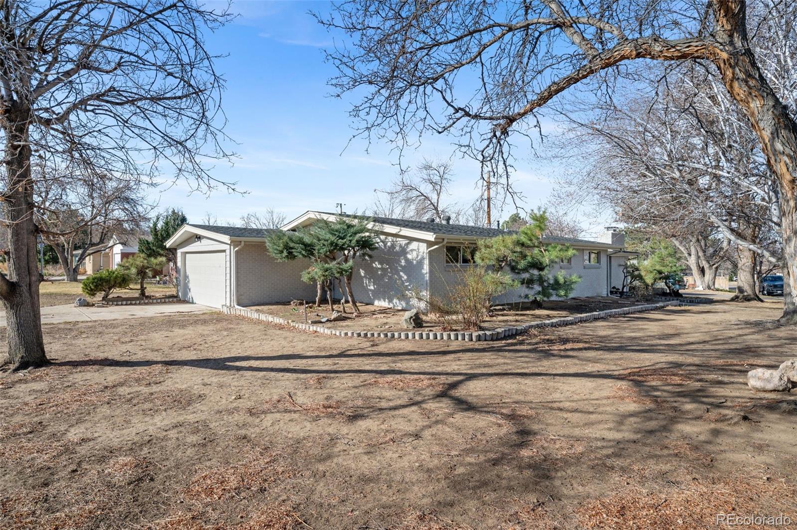 4481 Carr Street Wheat Ridge, CO 80033 - Photo 28 of 30 a view of a house with a yard and trees