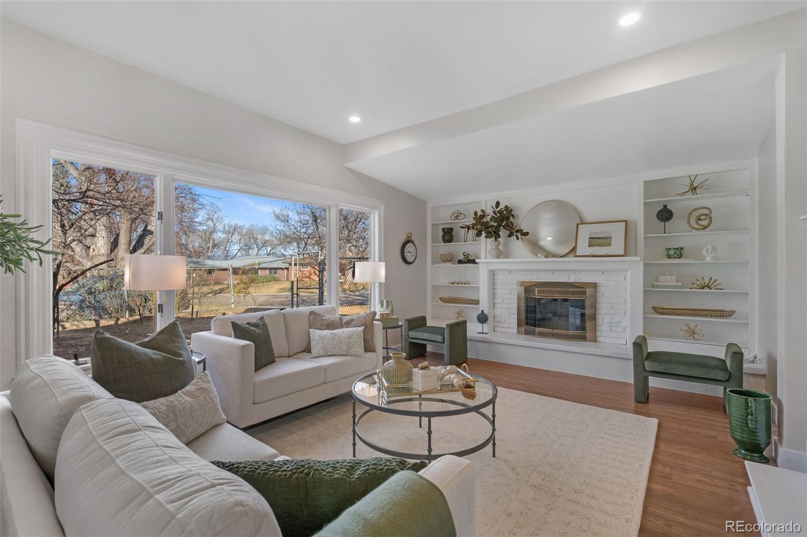 4481 Carr Street Wheat Ridge, CO 80033 - Photo 5 of 30 a living room with furniture and a fireplace