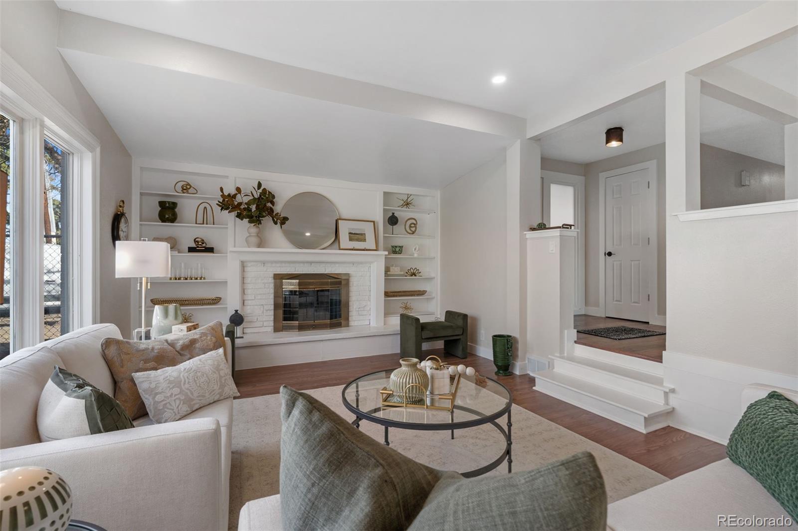 4481 Carr Street Wheat Ridge, CO 80033 - Photo 6 of 30 a living room with furniture and a fireplace