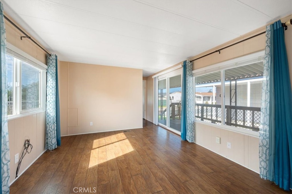 2300 Cienaga Street, Unit 36 Oceano, CA 93445 - Photo 11 of 39 wooden floor in an empty room with a window