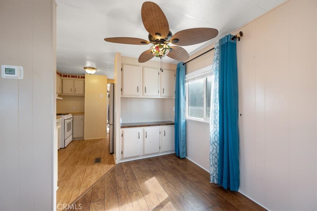 2300 Cienaga Street, Unit 36 Oceano, CA 93445 - Photo 12 of 39 a kitchen with granite countertop a refrigerator and a chandelier
