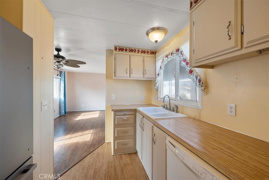 2300 Cienaga Street, Unit 36 Oceano, CA 93445 - Photo 16 of 39 a kitchen with a sink dishwasher a refrigerator and cabinets