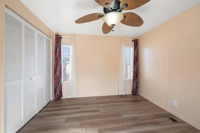 a view of a livingroom with a ceiling fan and window