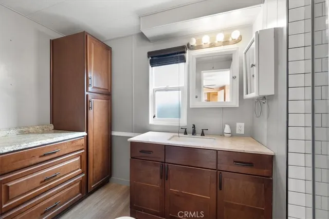 a bathroom with a shower sink and mirror