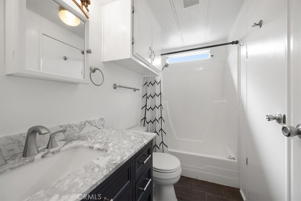 2300 Cienaga Street, Unit 36 Oceano, CA 93445 - Photo 24 of 39 a bathroom with a granite countertop sink toilet and shower