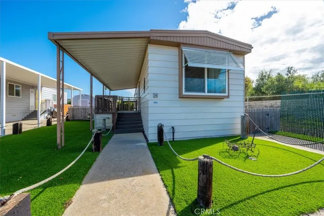 a view of a house with a swimming pool and a yard
