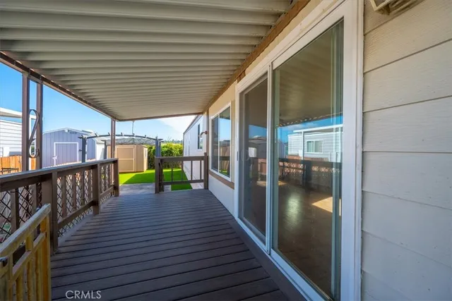a view of a big room with wooden floor and windows