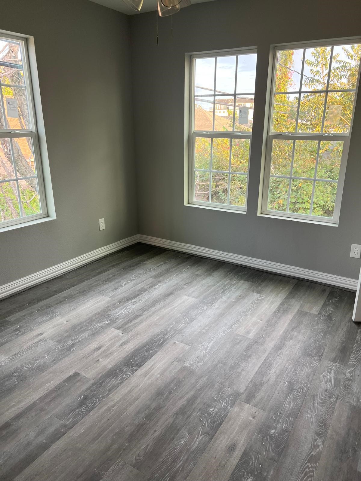 4011 Delano Street, Unit 4 Houston, TX 77004 - Photo 3 of 12 an empty room with wooden floor and windows
