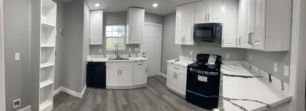 a kitchen with stainless steel appliances a stove a sink and a refrigerator