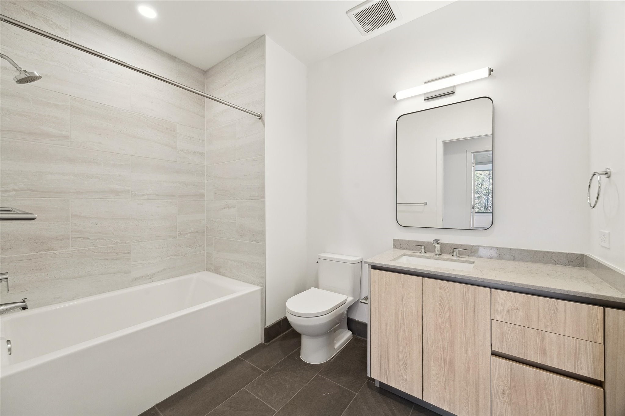 1 Riva Row, Unit 406 The Woodlands, TX 77380 - Photo 11 of 42 a bathroom with a granite countertop sink a toilet and bathtub