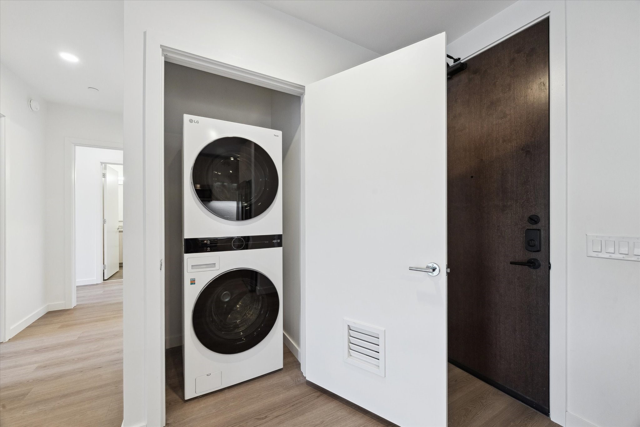 1 Riva Row, Unit 406 The Woodlands, TX 77380 - Photo 12 of 42 a view of a hallway with washer and dryer