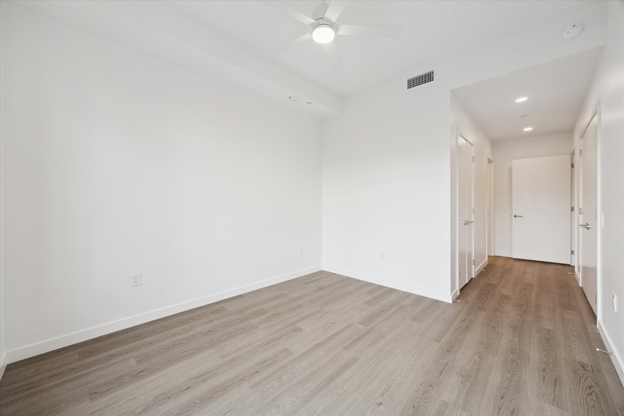 1 Riva Row, Unit 406 The Woodlands, TX 77380 - Photo 7 of 42 a view of an empty room with wooden floor