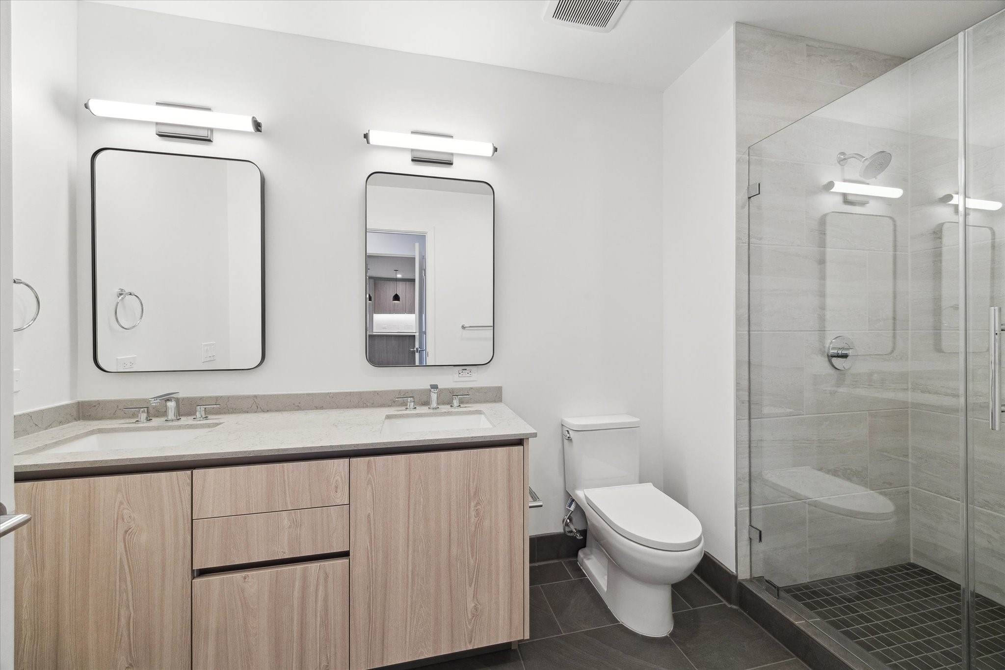 1 Riva Row, Unit 406 The Woodlands, TX 77380 - Photo 9 of 42 a bathroom with a toilet a sink and shower