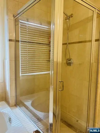 a bathroom with a shower and a tub