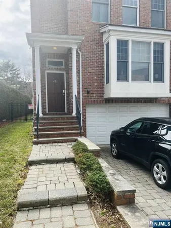 a view of a car parked side of the house