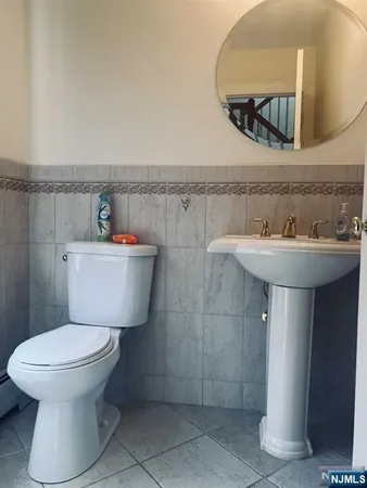 a bathroom with a sink toilet and a mirror