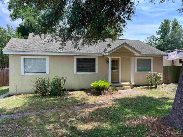 a front view of a house with a garden