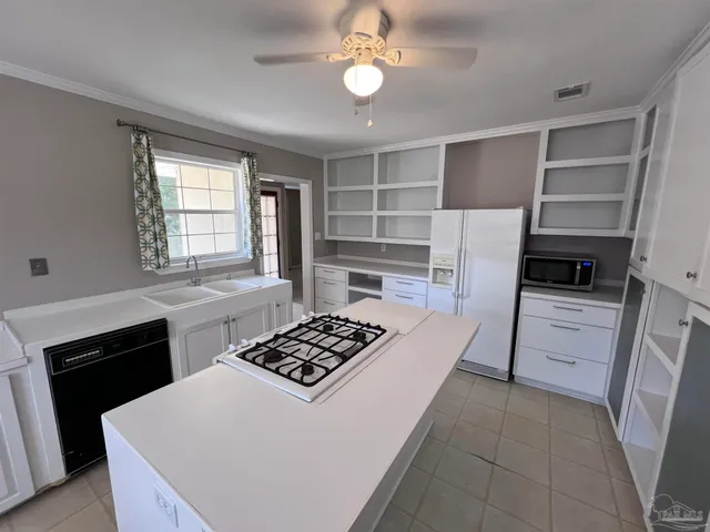 a kitchen with a stove and a refrigerator