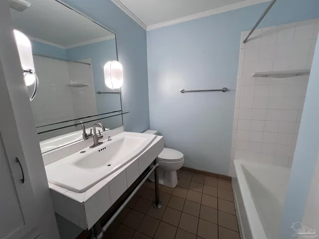 a bathroom with a sink toilet and mirror