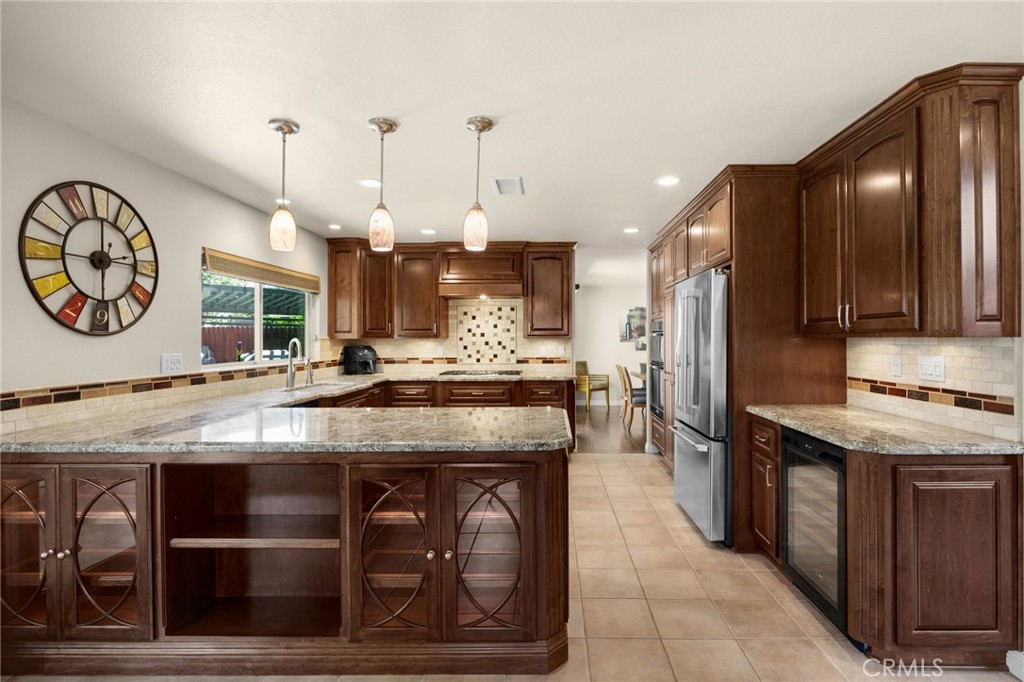 1412 Alta Mesa Way Brea, CA 92821 - Photo 29 of 50 a kitchen with stainless steel appliances granite countertop wooden cabinets a stove and a refrigerator