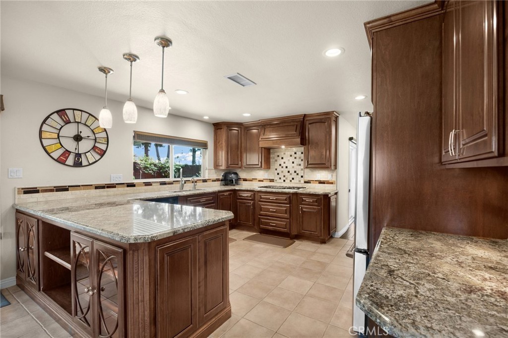 1412 Alta Mesa Way Brea, CA 92821 - Photo 30 of 50 a kitchen with a stove a faucet a refrigerator and cabinets