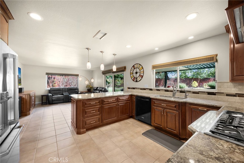 1412 Alta Mesa Way Brea, CA 92821 - Photo 33 of 50 a large kitchen with a stove a sink dishwasher and a refrigerator with wooden floor