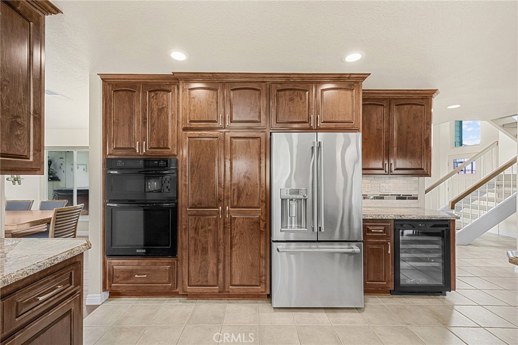 1412 Alta Mesa Way Brea, CA 92821 - Photo 34 of 50 a kitchen with stainless steel appliances granite countertop a refrigerator and a stove