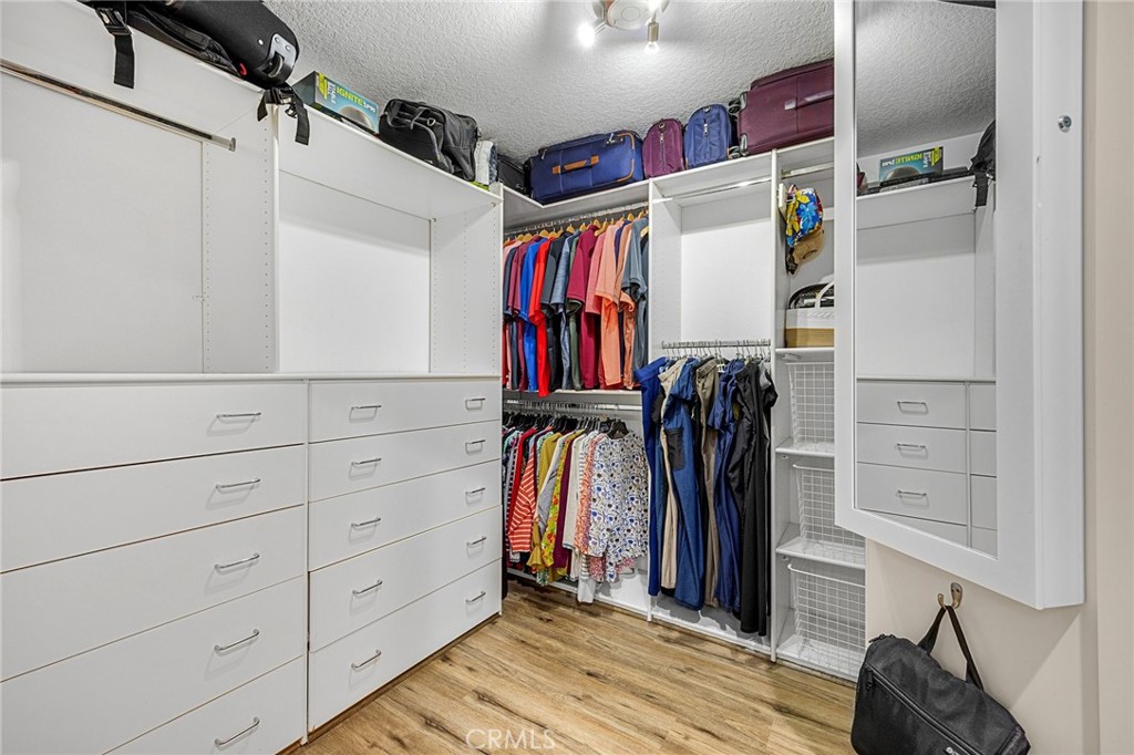 1412 Alta Mesa Way Brea, CA 92821 - Photo 45 of 50 a view of walk in closet with clothes and shoes