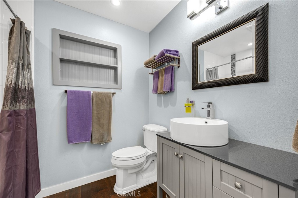 1412 Alta Mesa Way Brea, CA 92821 - Photo 48 of 50 a bathroom with a toilet sink and mirror