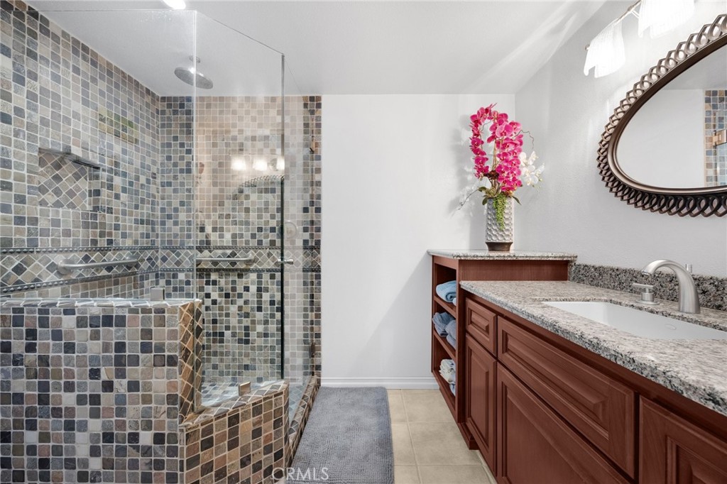 1412 Alta Mesa Way Brea, CA 92821 - Photo 8 of 50 a bathroom with a granite countertop shower a sink and a mirror