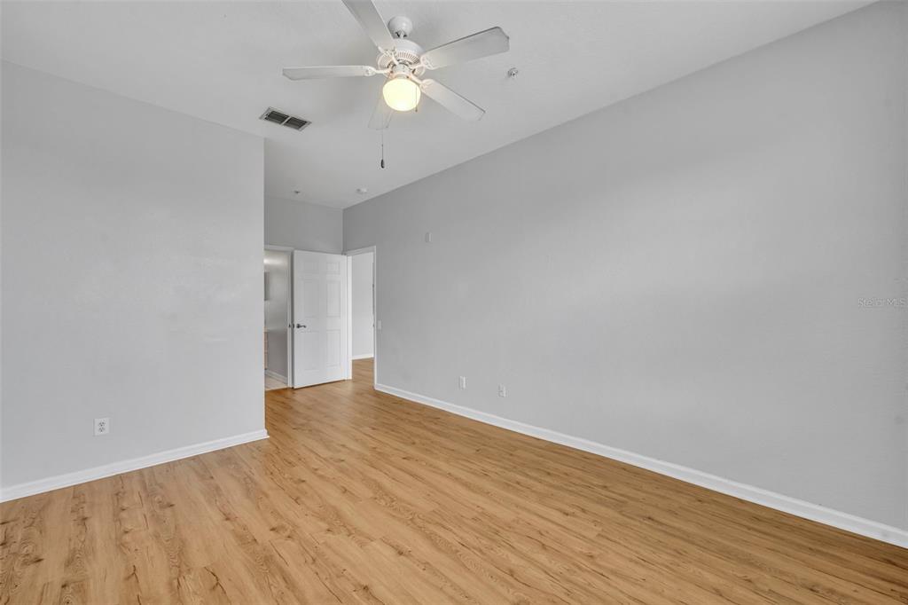 582 Brantley Terrace Way, Unit 304 Altamonte Springs, FL 32714 - Photo 22 of 30 an empty room with wooden floor and fan