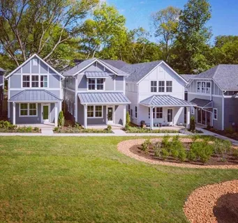 a front view of a house with swimming pool having outdoor seating