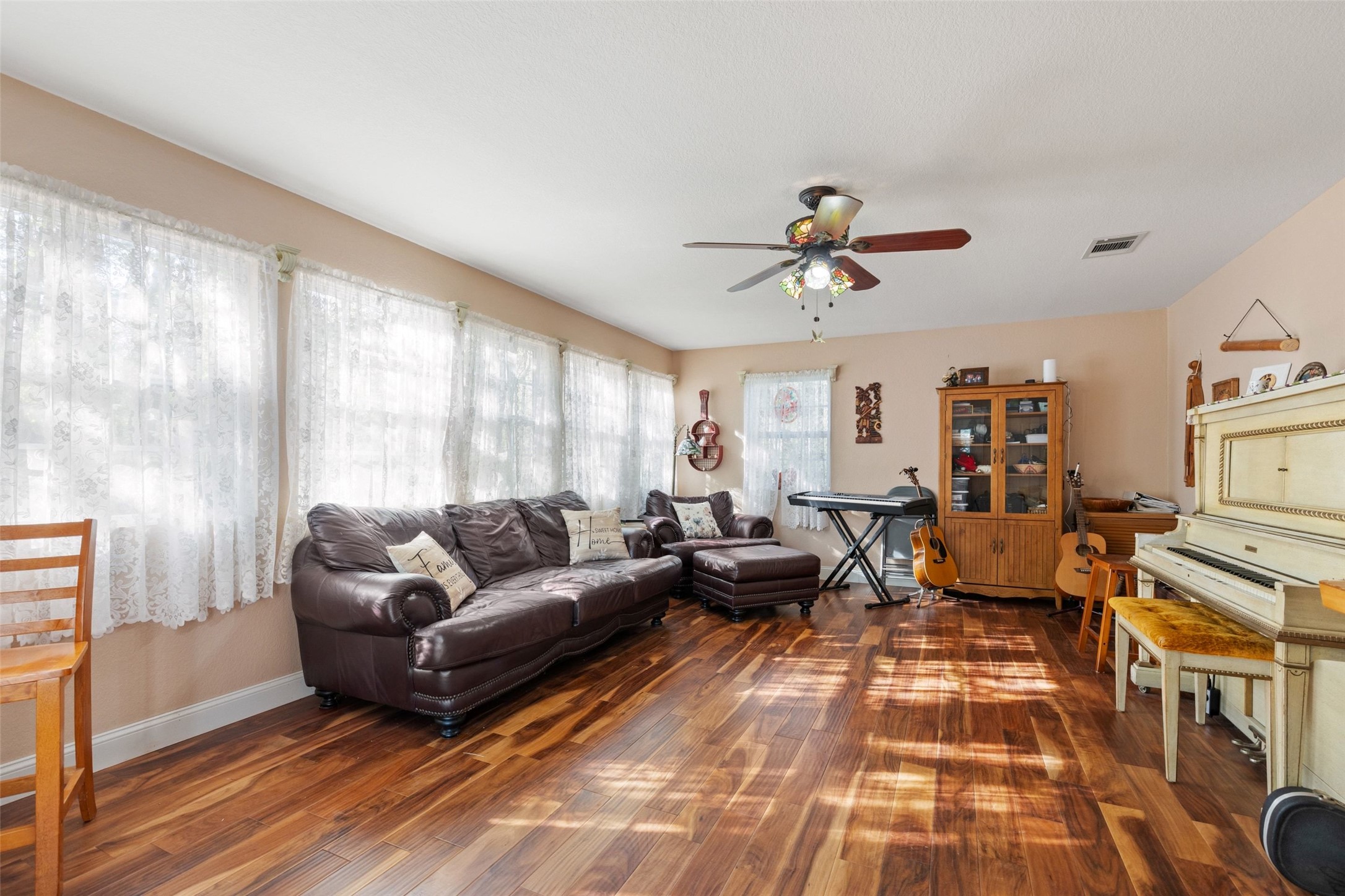 399 Upper Elgin River Road Elgin, TX 78621 - Photo 12 of 39 Living area featuring a ceiling fan and wood finished floors