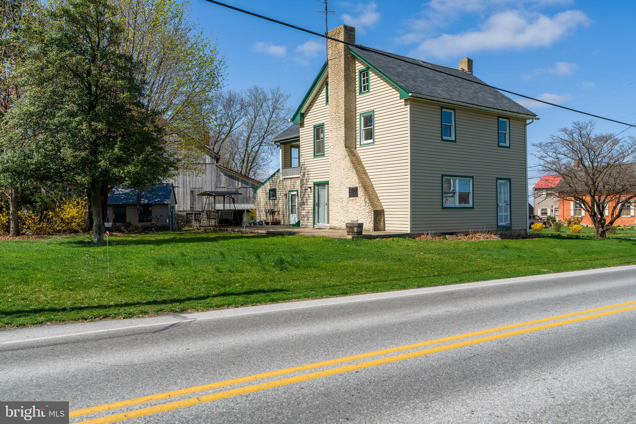 1 Prospect Road Strasburg, PA 17579 - Photo 8 of 66 a view of a white house with a small yard and large tree