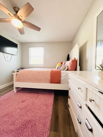 a bedroom with a bed and a dresser