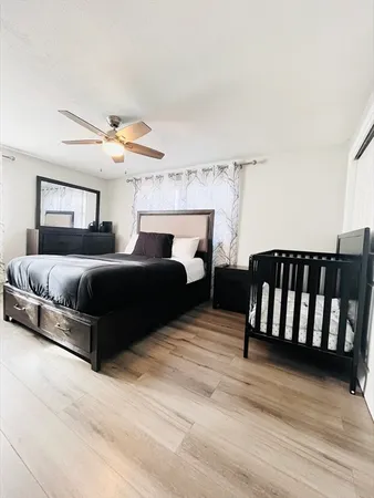 a bedroom with furniture and a wooden floor