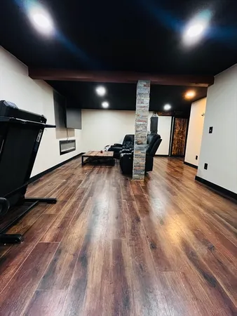 a view of a room with wooden floor