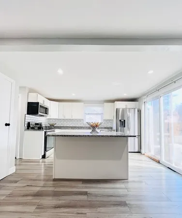 a kitchen with stainless steel appliances a sink and cabinets