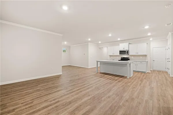 a view of kitchen with wooden floor and window