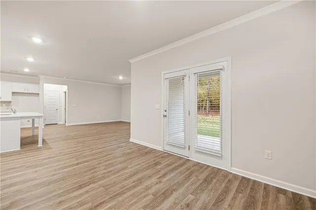 a view of kitchen with wooden floor and window
