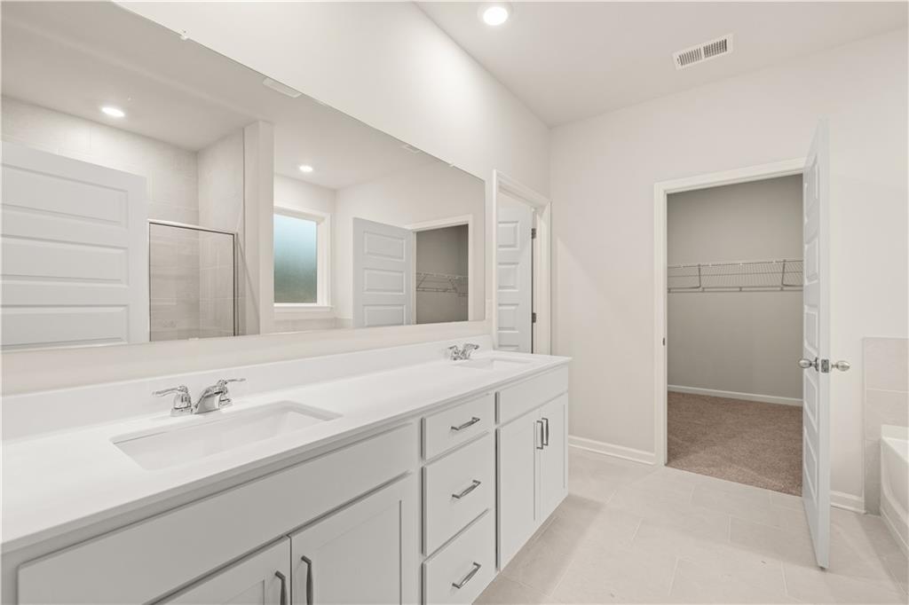 1171 Kingston Road Buckhead, GA 30625 - Photo 18 of 34 a bathroom with a sink double vanity and a mirror