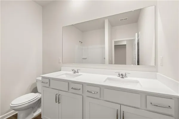 a bathroom with a sink toilet and mirror