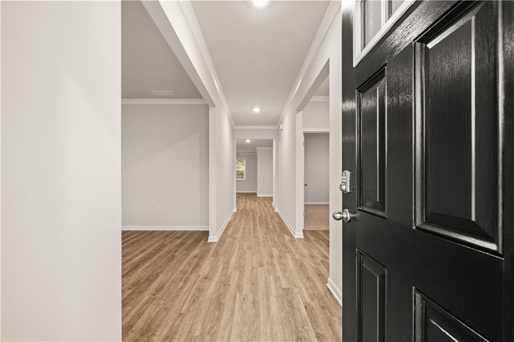 1171 Kingston Road Buckhead, GA 30625 - Photo 6 of 34 a view of a hallway with wooden floor and staircase